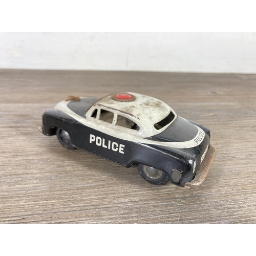 411A - Two mid 20th century tinplate model police cars to include PN-300 etc.