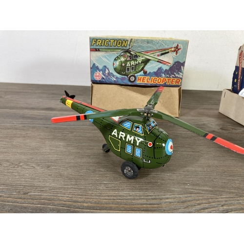 411B - Two boxed model vehicles, one Marx H-1993 tinplate friction helicopter and one training plane