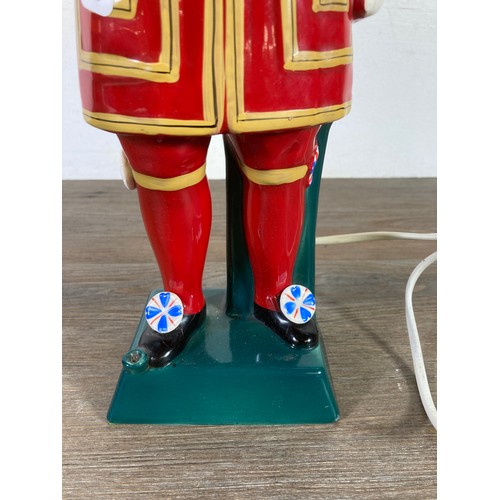 322A - A Carlton Ware Ltd hand painted ceramic Beefeater table lamp - approx. 48cm high