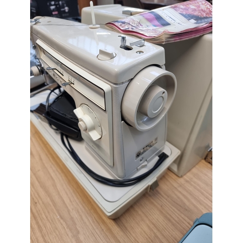 770 - A cased Singer 507 electric sewing machine with foot pedal and instruction manual