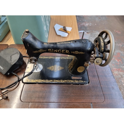 772 - A sewing machine table containing Singer electric sewing machine with foot pedal