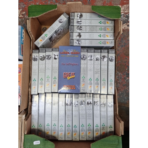 734 - Six boxes, three containing sealed DVDs two containing VHS videos and one containing Sanyo HV-DX1 DV... 