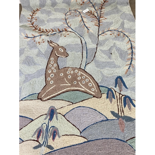 445 - An embroidered wall hanging with deer design - approx. 65cm high x 47cm wide