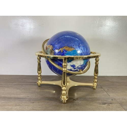 480 - A polished semi precious stone and brass terrestrial globe - approx. 45cm high