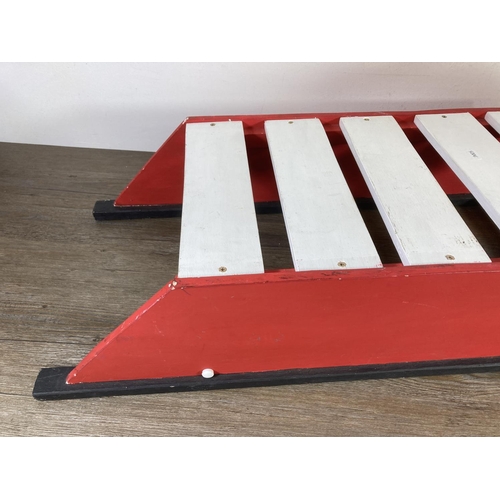 481 - A red and white painted wooden sledge - approx. 37cm high x 100cm long x 35cm deep