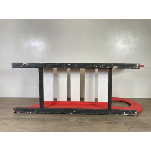 481 - A red and white painted wooden sledge - approx. 37cm high x 100cm long x 35cm deep