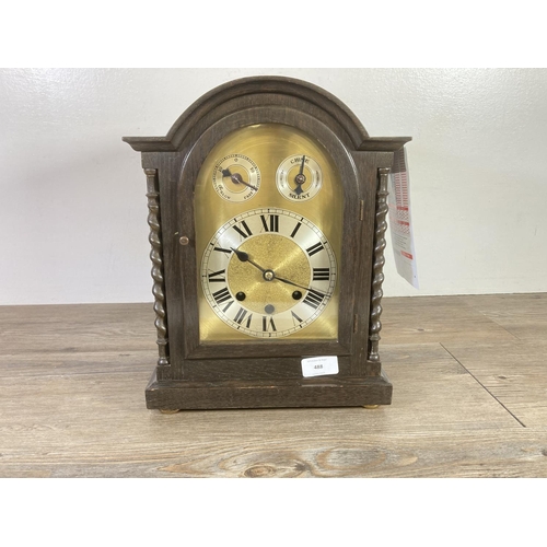 488 - A mid 20th century oak cased Westminster chiming mantel clock with key and pendulum - approx. 34cm h... 