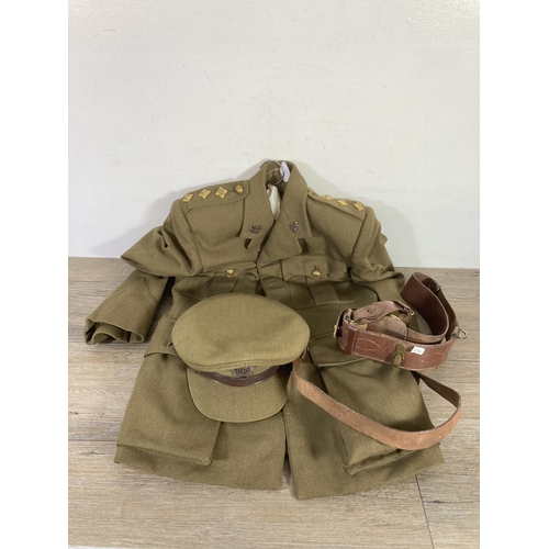 504 - A vintage Cheshire Regiment military jacket with peaked cap and leather belt