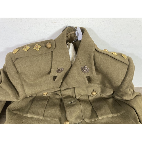 504 - A vintage Cheshire Regiment military jacket with peaked cap and leather belt