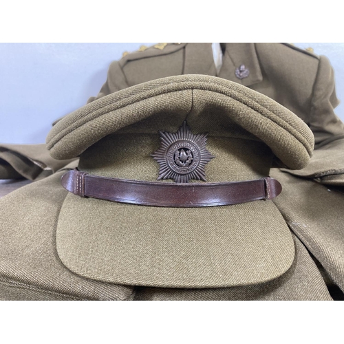 504 - A vintage Cheshire Regiment military jacket with peaked cap and leather belt