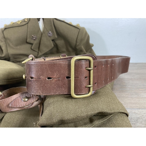 504 - A vintage Cheshire Regiment military jacket with peaked cap and leather belt