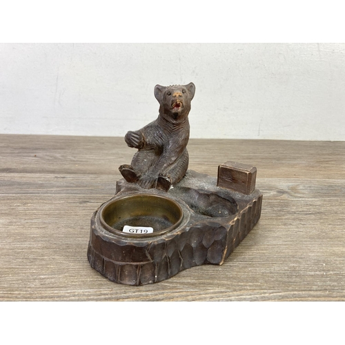 512 - An antique Black Forest carved bear pipe rack and ash tray - approx. 14cm high x 14cm wide