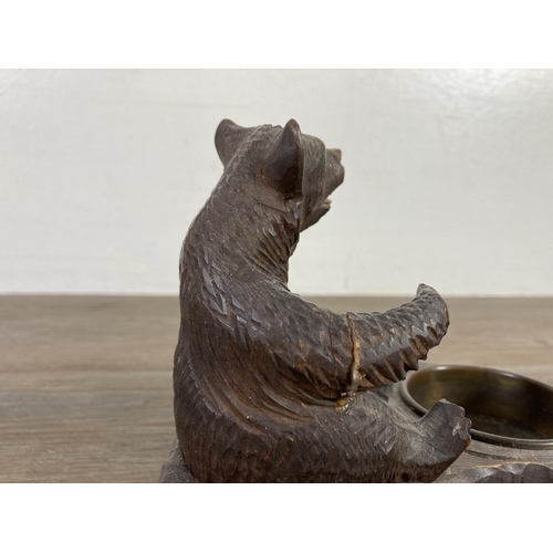 512 - An antique Black Forest carved bear pipe rack and ash tray - approx. 14cm high x 14cm wide