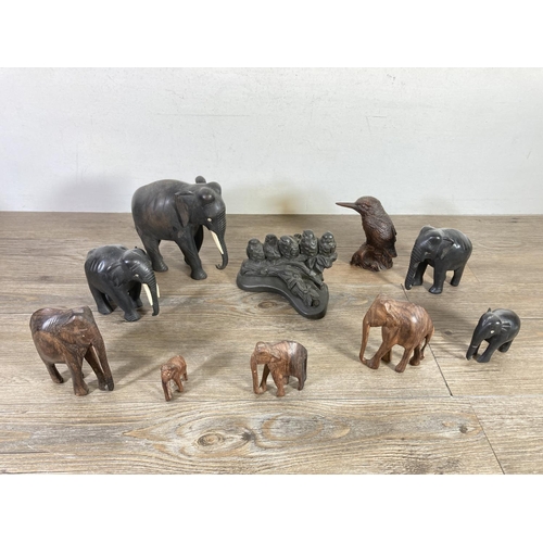 518 - Ten figurines comprising four carved ebony elephants, four carved hardwood elephants, one Priory Cas... 