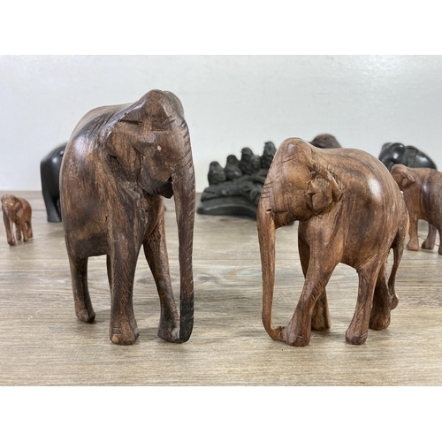 518 - Ten figurines comprising four carved ebony elephants, four carved hardwood elephants, one Priory Cas... 