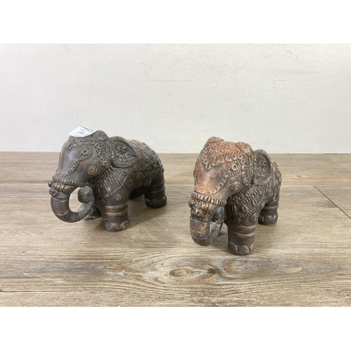 522 - Two Indian handmade clay elephant figurines - approx. 15cm high x 7cm wide