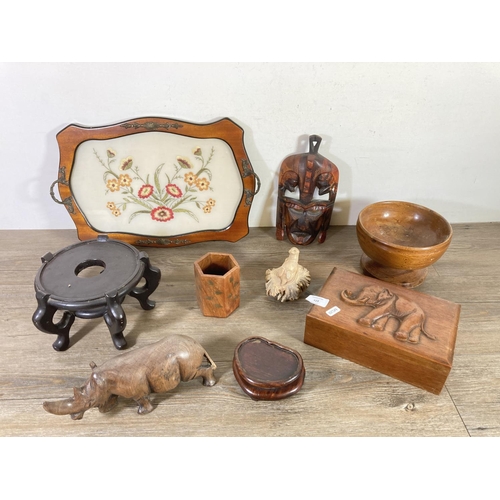 523 - A collection of treenware to include tribal wall mask, carved teak jewellery box with elephant desig... 