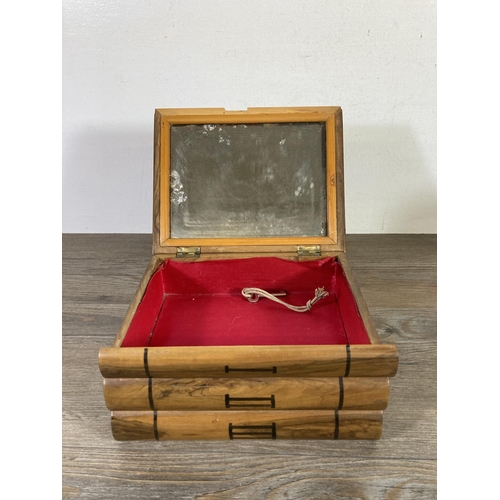 525 - Three early 20th century Jerusalem olive wood items, 20cm candlestick, pressed flowers book and puzz... 