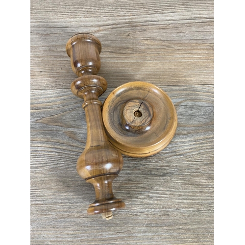 525 - Three early 20th century Jerusalem olive wood items, 20cm candlestick, pressed flowers book and puzz... 