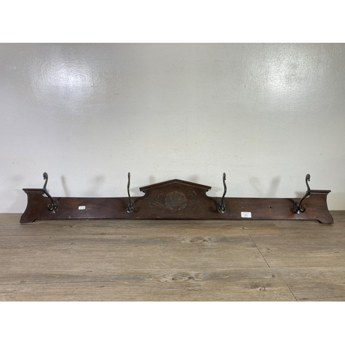 526 - An Edwardian mahogany wall mountable coat hanger with four hooks - approx. 125cm wide x 16cm high