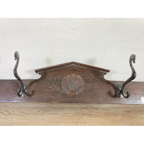 526 - An Edwardian mahogany wall mountable coat hanger with four hooks - approx. 125cm wide x 16cm high