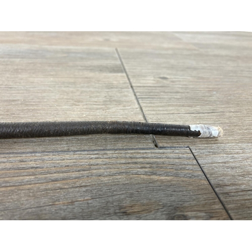 543 - An early 20th century leather and white metal riding crop - approx. 57cm long