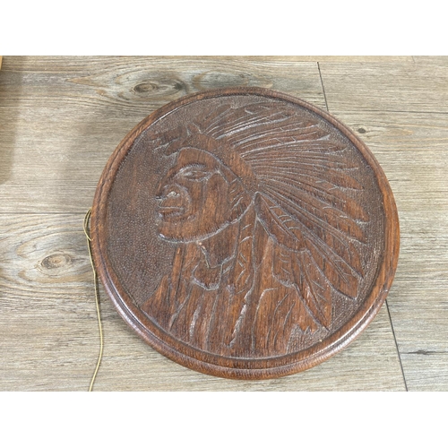 544 - A collection of treenware to include Native American carved oak circular wall plaque, African carved... 