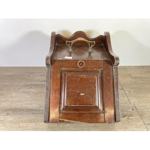 545 - A late 19th/early 20th century mahogany coal scuttle with brass handle - approx. 34cm high x 35cm wi... 