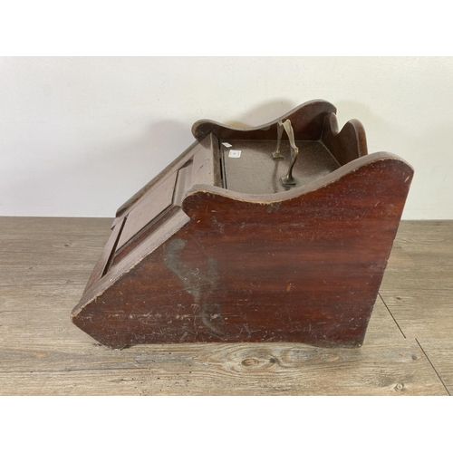 545 - A late 19th/early 20th century mahogany coal scuttle with brass handle - approx. 34cm high x 35cm wi... 