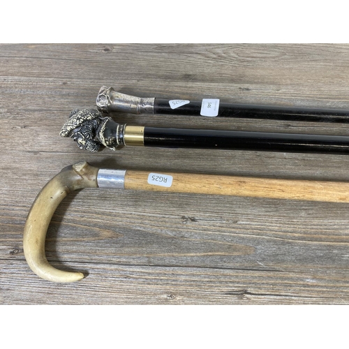 546 - Three walking canes, hallmarked Birmingham silver topped, resin Scotsman head and antler