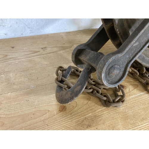 553 - A late 19th/early 20th century cast iron pulley wheel and chain - approx. 55cm high x 45cm wide