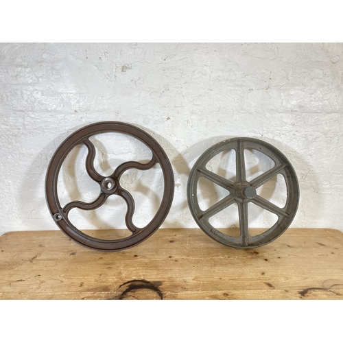 554 - Two late 19th/early 20th century cast iron mill wheels - largest approx. 52cm diameter