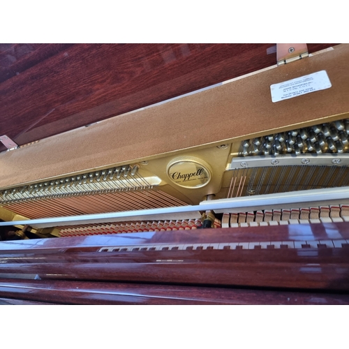 764 - A gloss mahogany Chappell eighty-eight key, three pedal upright piano with duet stool containing she... 