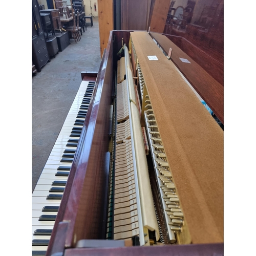 764 - A gloss mahogany Chappell eighty-eight key, three pedal upright piano with duet stool containing she... 