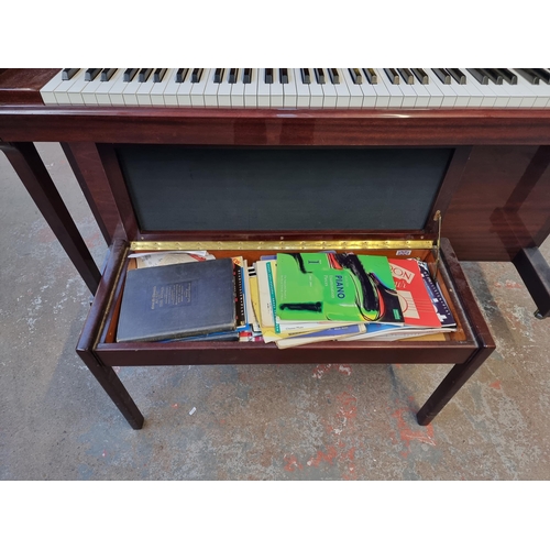 764 - A gloss mahogany Chappell eighty-eight key, three pedal upright piano with duet stool containing she... 