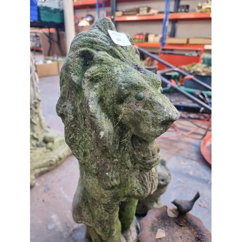 848 - Three garden ornaments, one cast stone lion approx 53cm high, one cast stone cat approx 20cms high a... 