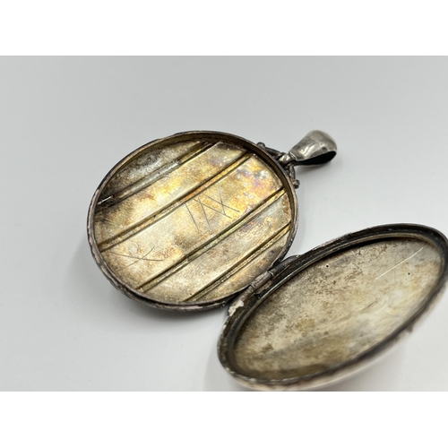 2128 - A Victorian hallmarked Birmingham silver oval etched photo locket pendant, dated 1881 - approx. gros... 