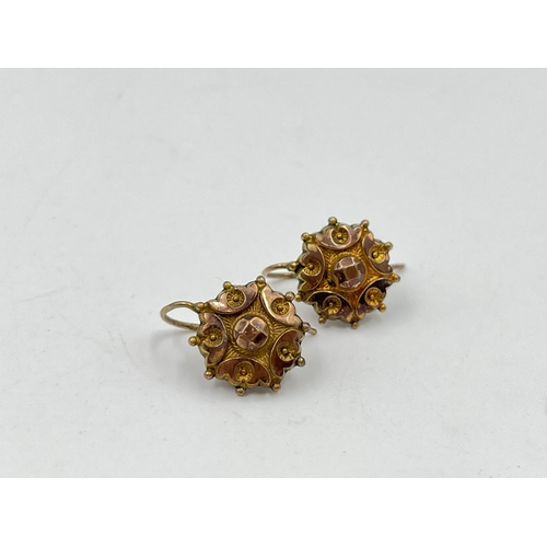 2142 - A pair of early 20th century yellow metal hook earrings - approx. gross weight 1.25 grams