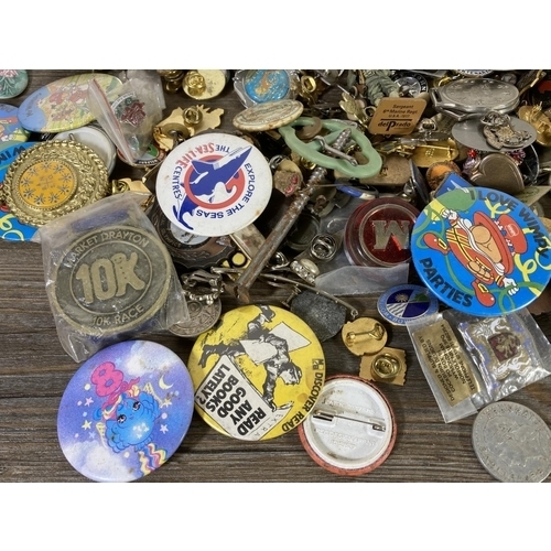 439 - A large collection of vintage pin badges