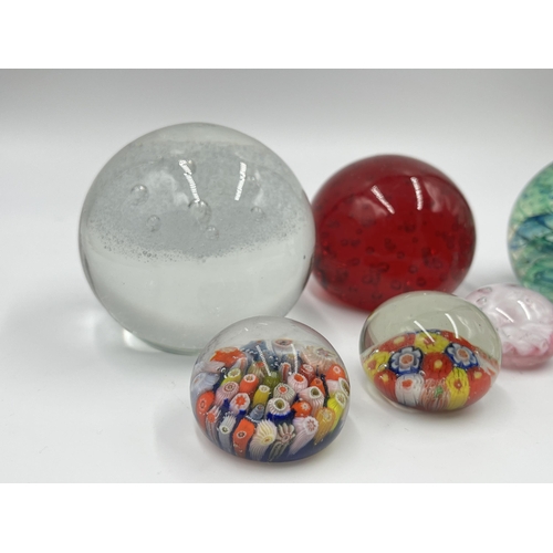 304 - Seven studio glass paperweights to include Caithness Spinaway, Rosenthal, Millefiori etc.