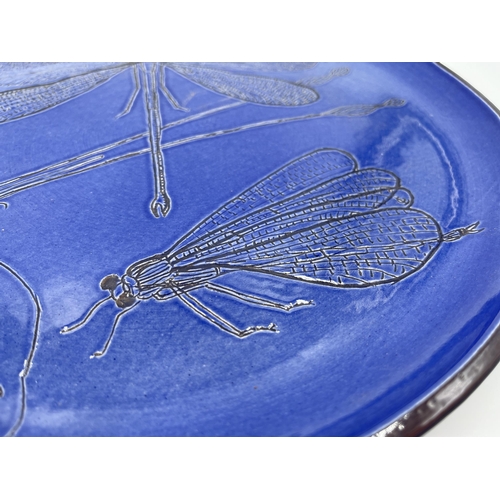 310 - A blue studio pottery dragonfly design plate - approx. 30cm diameter