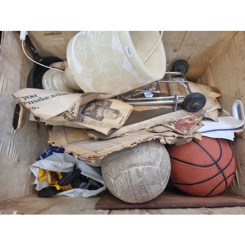 867 - Two wooden crates containing vintage fishing rods, walking sticks, basket ball, footballs, alabaster... 