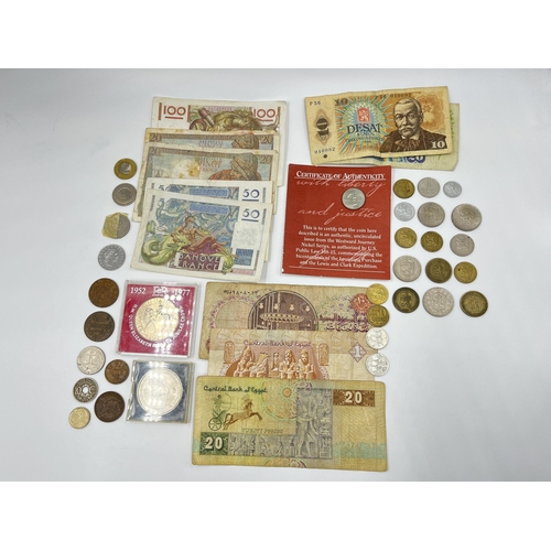 2374 - A collection of worldwide currency to include 240 Francs, 31 Egyptian pounds, 1977 Elizabeth II silv... 