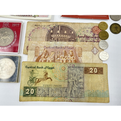 2374 - A collection of worldwide currency to include 240 Francs, 31 Egyptian pounds, 1977 Elizabeth II silv... 