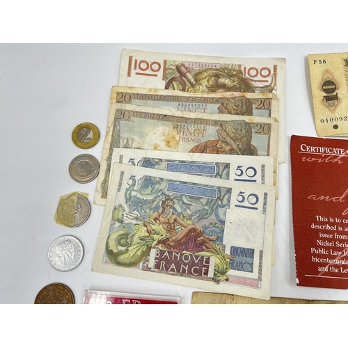 2374 - A collection of worldwide currency to include 240 Francs, 31 Egyptian pounds, 1977 Elizabeth II silv... 