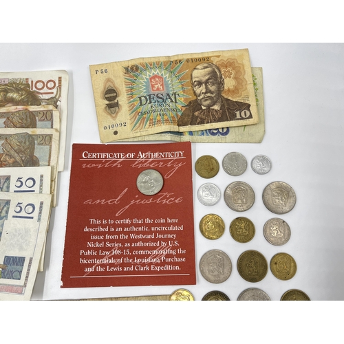 2374 - A collection of worldwide currency to include 240 Francs, 31 Egyptian pounds, 1977 Elizabeth II silv... 