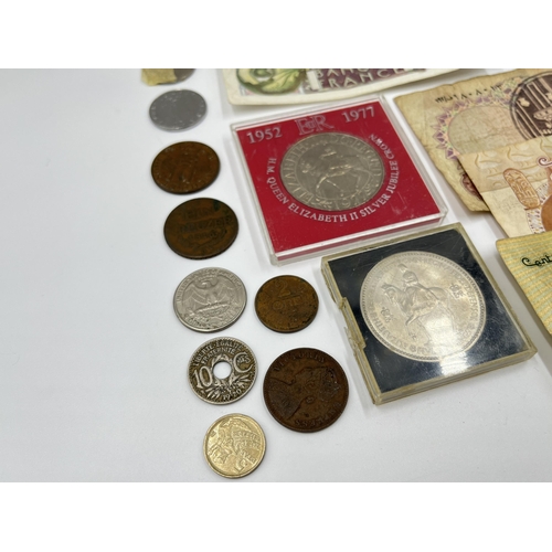 2374 - A collection of worldwide currency to include 240 Francs, 31 Egyptian pounds, 1977 Elizabeth II silv... 