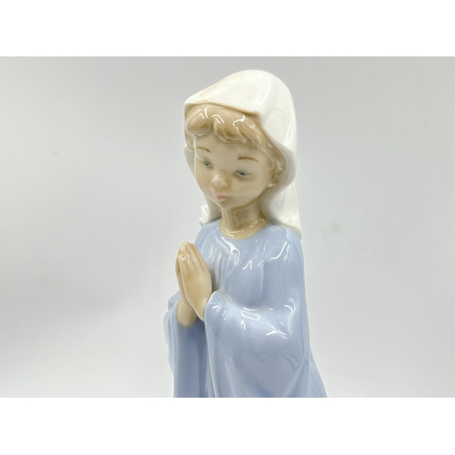 248 - Three Spanish porcelain figurines, two Nao by Lladro and one Miquel Requena - largest approx. 27cm h... 