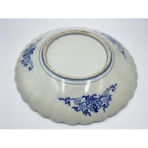 276 - An Oriental blue and white transfer printed porcelain charger with bird and foliate design - approx.... 