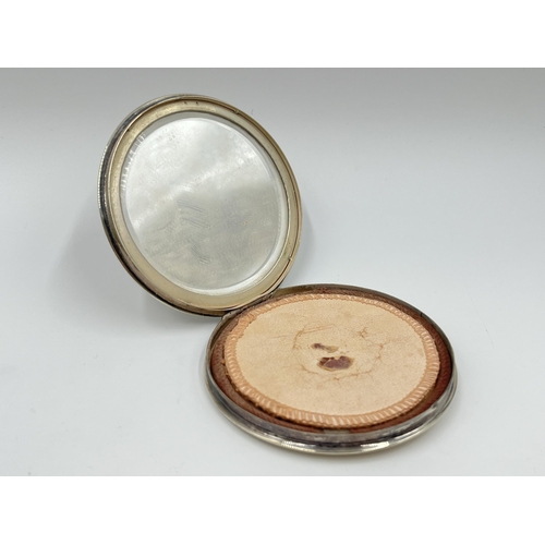 2250 - A white metal circular compact mirror - approx. 7.5cm diameter and gross weight 75 grams